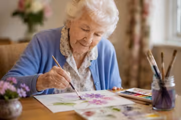 A resident enjoying a painting activity